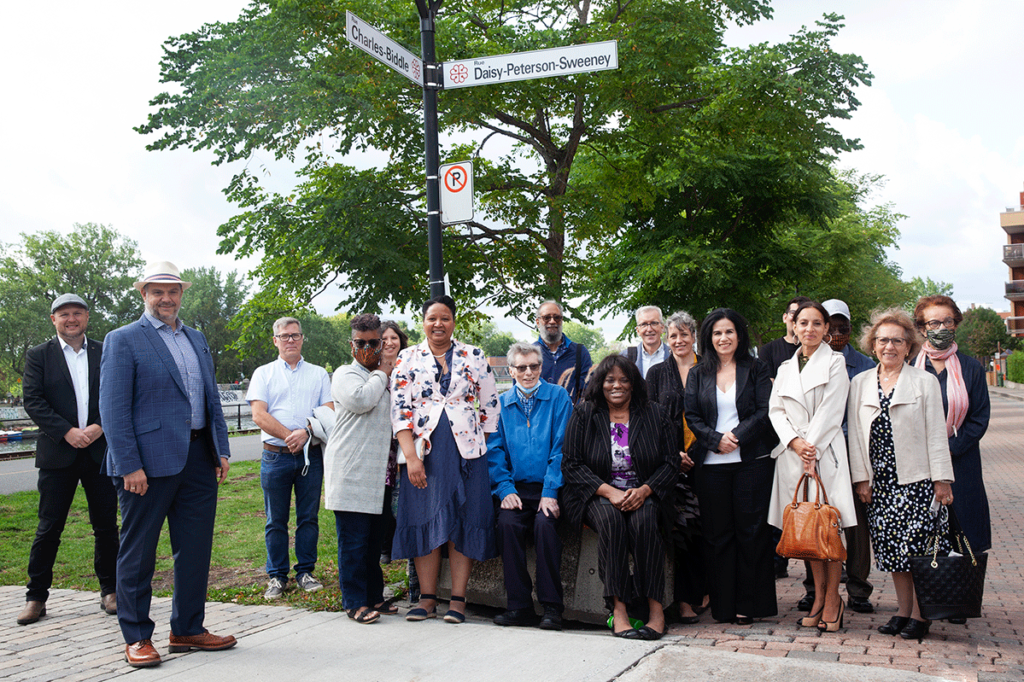 Group photo under the Daisy Peterson Sweeney Street signed, named for his contribution to music in Montreal, Quebec, Canada and throughout the world.